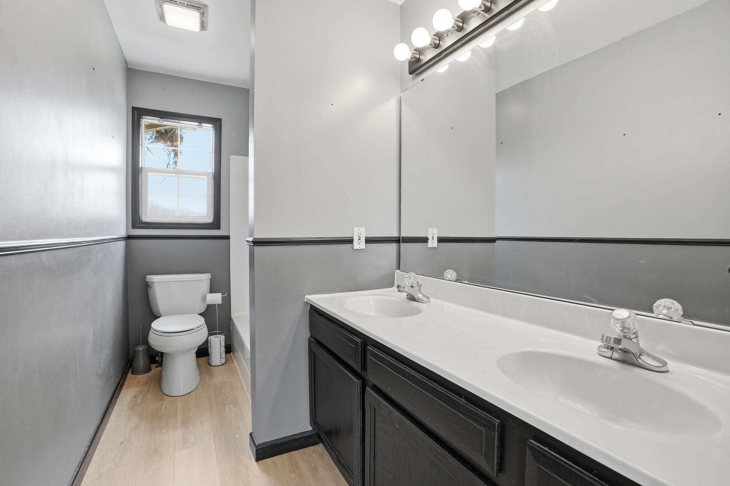 12358 Tippecanoe Place Crown Point, IN 46307 - Photo 20 of 30 a bathroom with a sink a toilet and a mirror