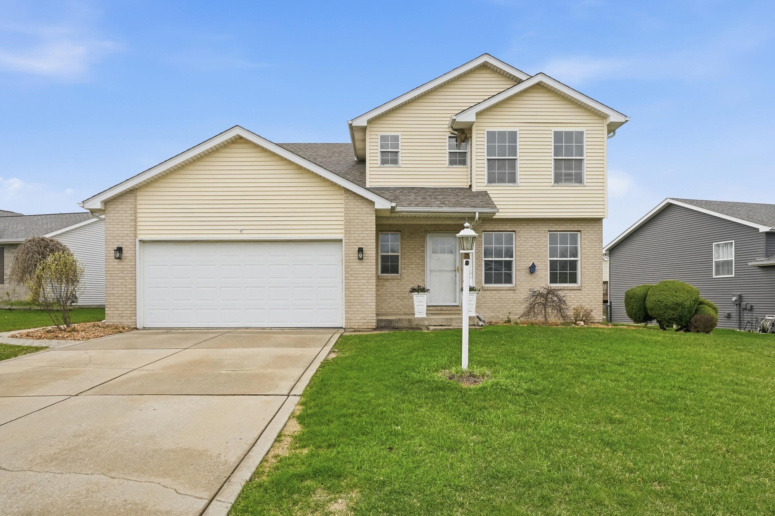 12358 Tippecanoe Place Crown Point, IN 46307 - Photo 30 of 30 a front view of a house with a yard and garage
