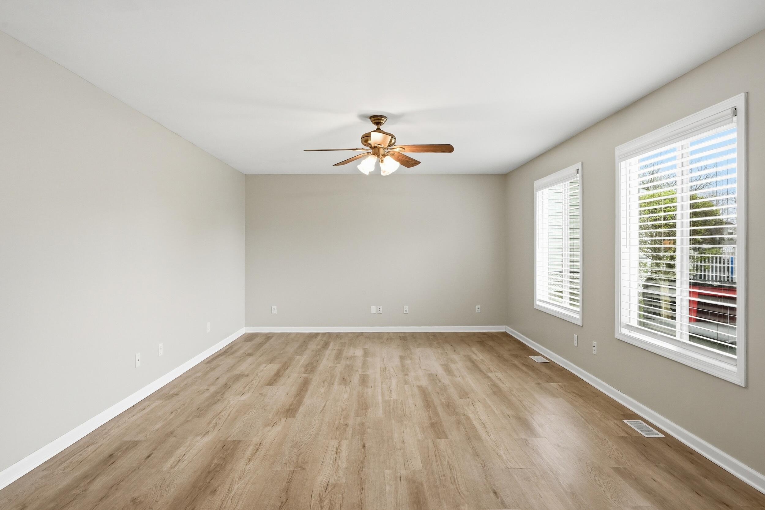 12358 Tippecanoe Place Crown Point, IN 46307 - Photo 8 of 30 wooden floor in an empty room with a window