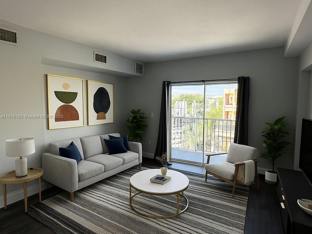 134 Southwest 7th Avenue, Unit 402 Miami, FL 33130 - Photo 4 of 19 a living room with furniture and a large window