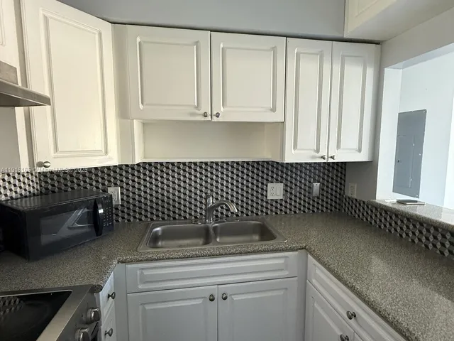 a kitchen with a sink and cabinets