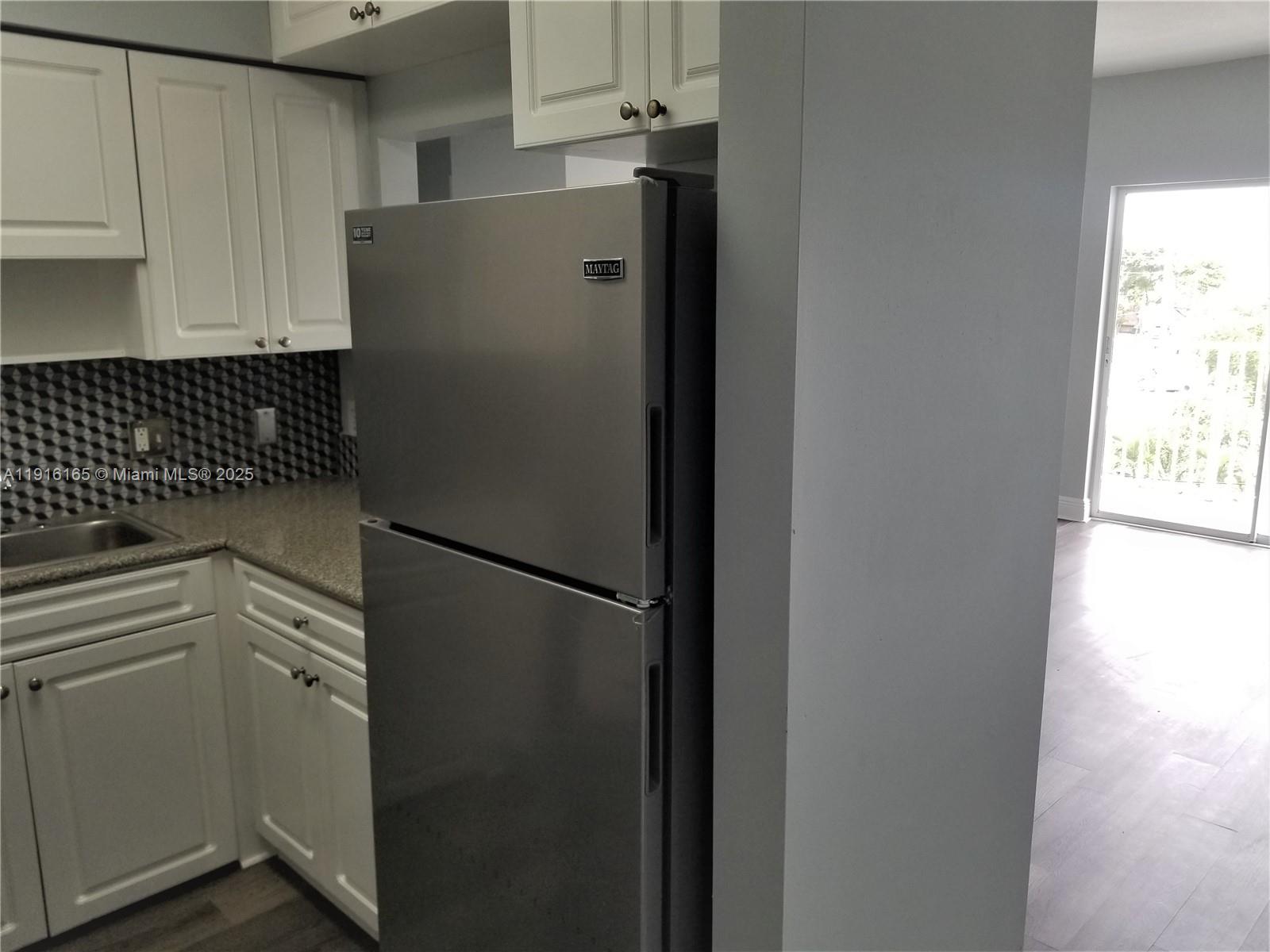 134 Southwest 7th Avenue, Unit 402 Miami, FL 33130 - Photo 9 of 19 a white refrigerator freezer sitting inside of a kitchen