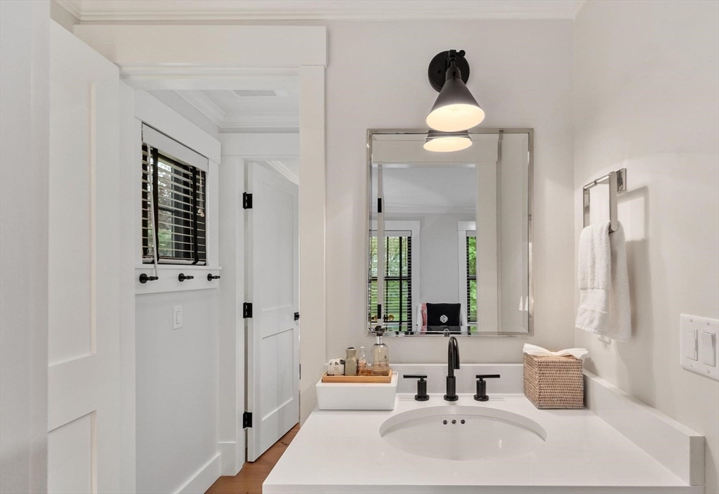 653 Main Street Concord, MA 01742 - Photo 33 of 42 a bathroom with a sink and a mirror