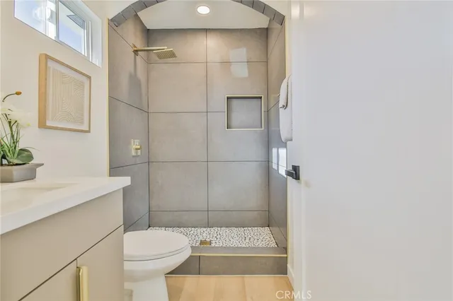 a bathroom with a sink a toilet and shower