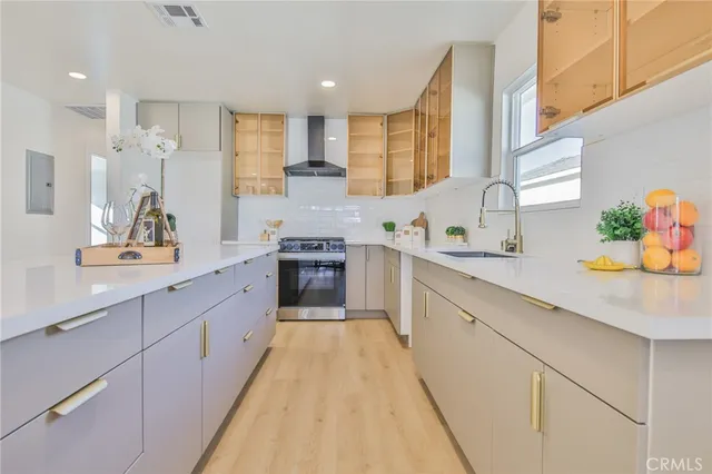 a large kitchen with stainless steel appliances lots of counter space and a sink