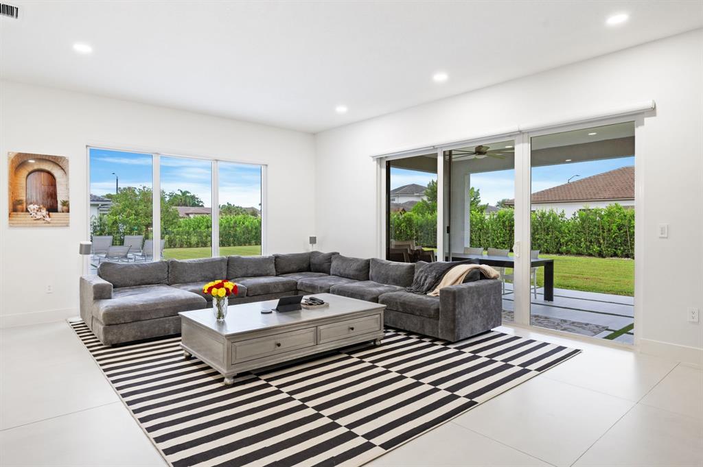 2001 Meadows Drive Davie, FL 33324 - Photo 13 of 40 a living room with furniture and a floor to ceiling window