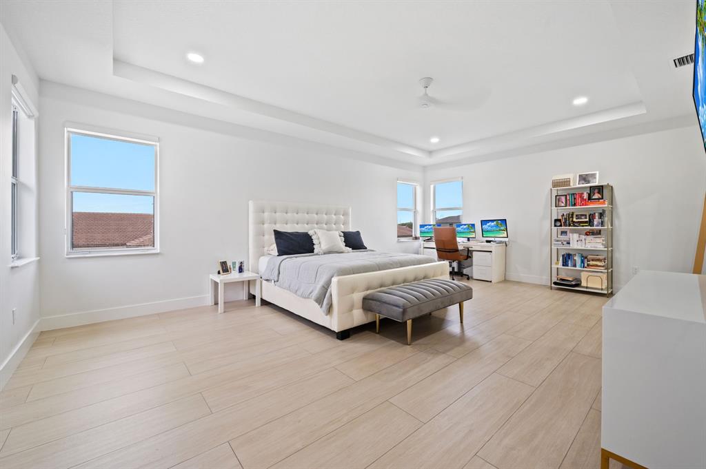 2001 Meadows Drive Davie, FL 33324 - Photo 15 of 40 a spacious bedroom with a bed a couch and a window