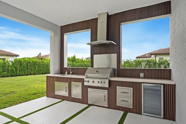 a open kitchen with stainless steel appliances granite countertop a stove a sink and a yard