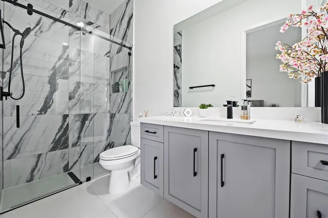 a bathroom with a sink toilet and shower