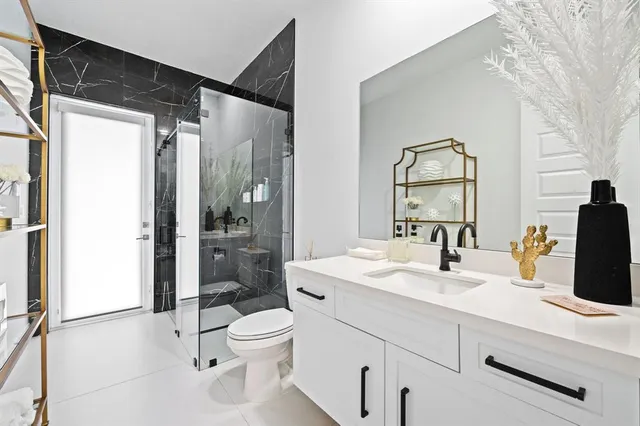 a bathroom with a sink toilet and shower