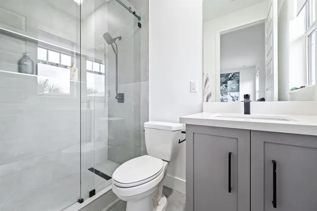 a bathroom with a sink toilet and shower
