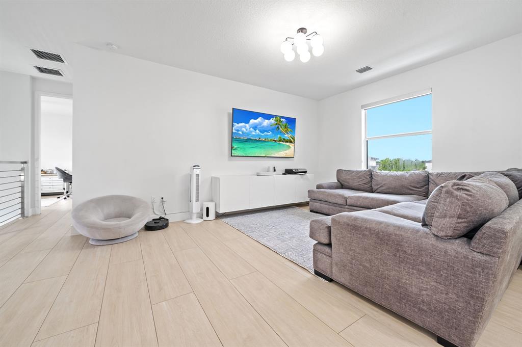 2001 Meadows Drive Davie, FL 33324 - Photo 27 of 40 a living room with furniture a flat screen tv and a window