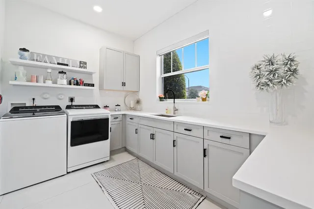 a kitchen with cabinets stainless steel appliances and a sink