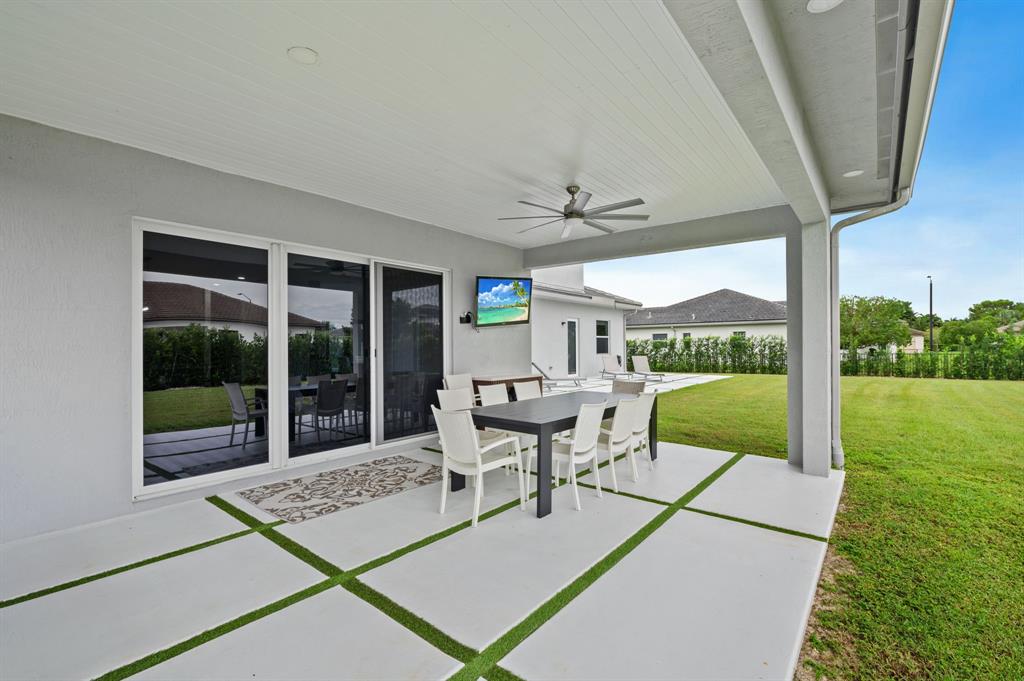 2001 Meadows Drive Davie, FL 33324 - Photo 35 of 40 a view of a patio with a dining table and chairs