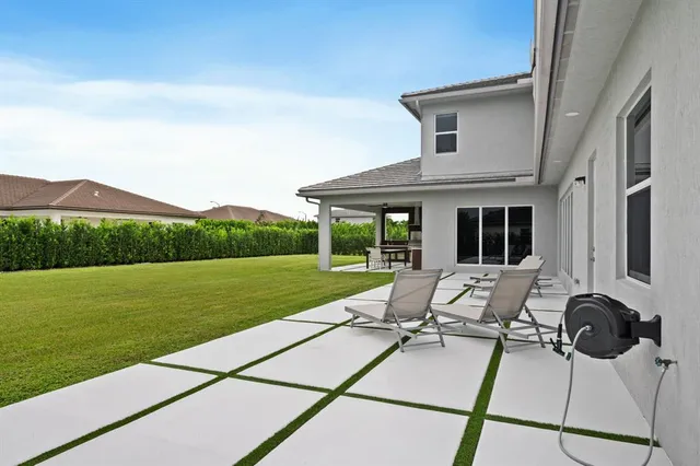 a view of a house with backyard porch and garden