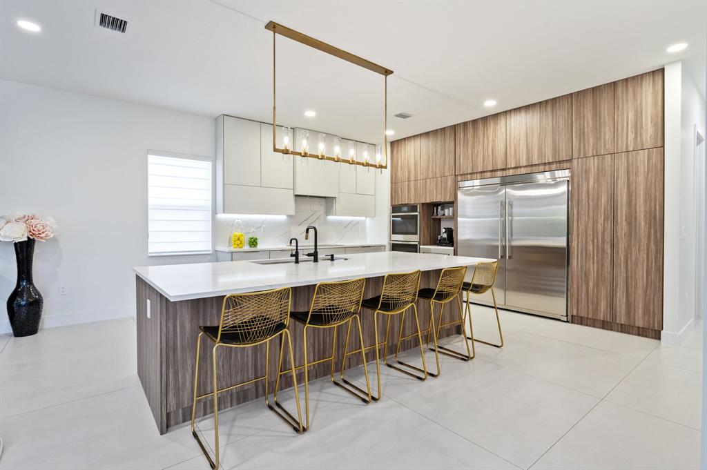 2001 Meadows Drive Davie, FL 33324 - Photo 6 of 40 a kitchen with kitchen island a sink stove and refrigerator