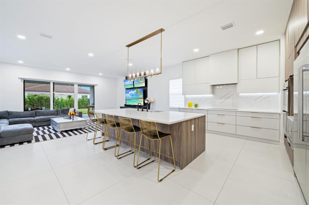 2001 Meadows Drive Davie, FL 33324 - Photo 9 of 40 a kitchen with stainless steel appliances granite countertop a stove a sink and a refrigerator