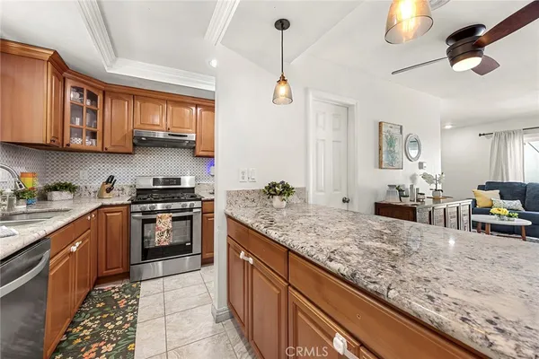 a kitchen with stainless steel appliances granite countertop a sink stove and refrigerator