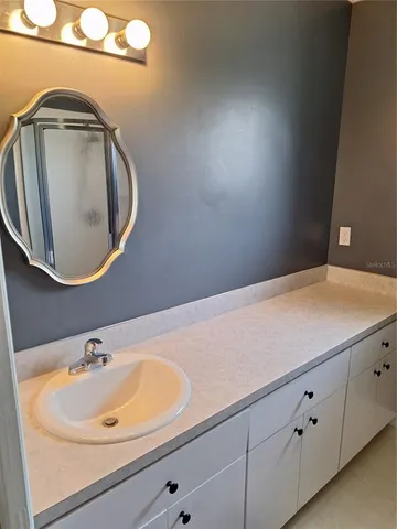 a bathroom with a sink and a mirror