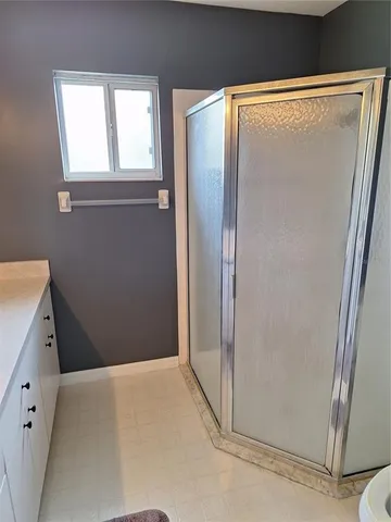 a bathroom with a shower and a tub