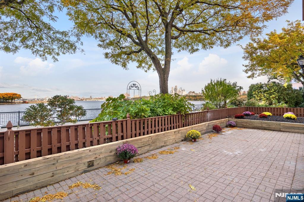 105 Nelson Court Edgewater, NJ 07020 - Photo 16 of 18 a view of a roof deck with wooden fence and trees