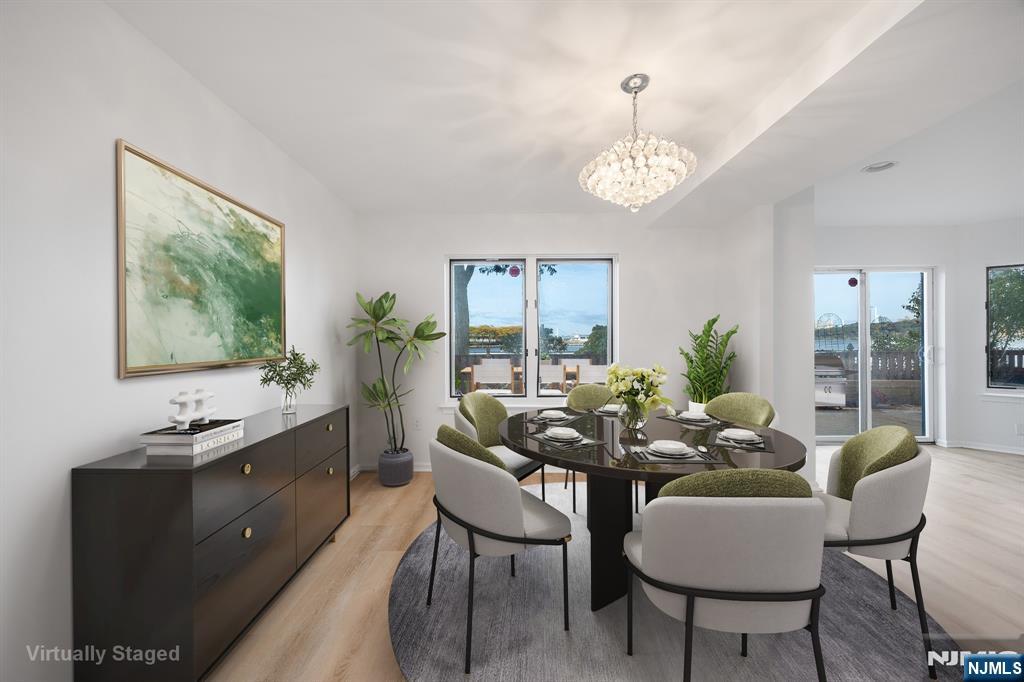 105 Nelson Court Edgewater, NJ 07020 - Photo 2 of 18 a dining room with furniture a livingroom view and wooden floor