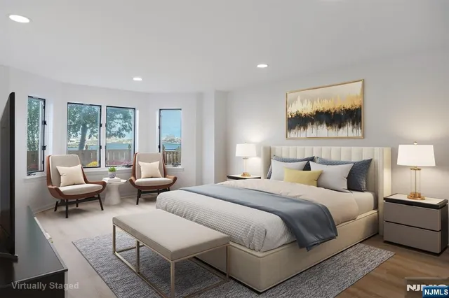 a bedroom with furniture and a large window