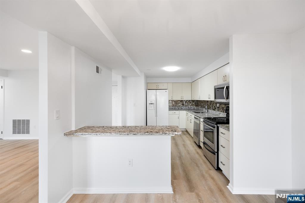 105 Nelson Court Edgewater, NJ 07020 - Photo 6 of 18 a view of kitchen with granite countertop cabinets and stainless steel appliances