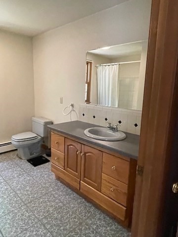 140 South Shaker Road Harvard, MA 01451 - Photo 16 of 38 a bathroom with a granite countertop sink a toilet and a mirror