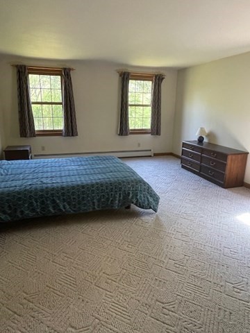 140 South Shaker Road Harvard, MA 01451 - Photo 17 of 38 a spacious bedroom with a bed and a window