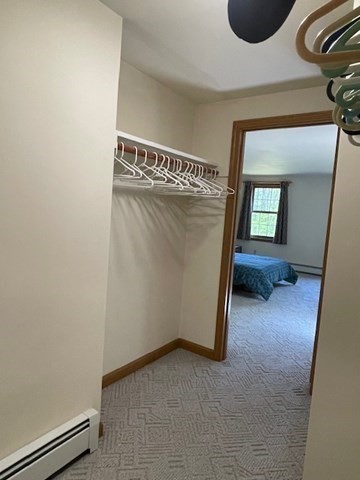 140 South Shaker Road Harvard, MA 01451 - Photo 20 of 38 a view of a hallway with wooden floor and a cabinet