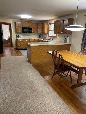 140 South Shaker Road Harvard, MA 01451 - Photo 5 of 38 a kitchen with kitchen island a stove a table and chairs in it
