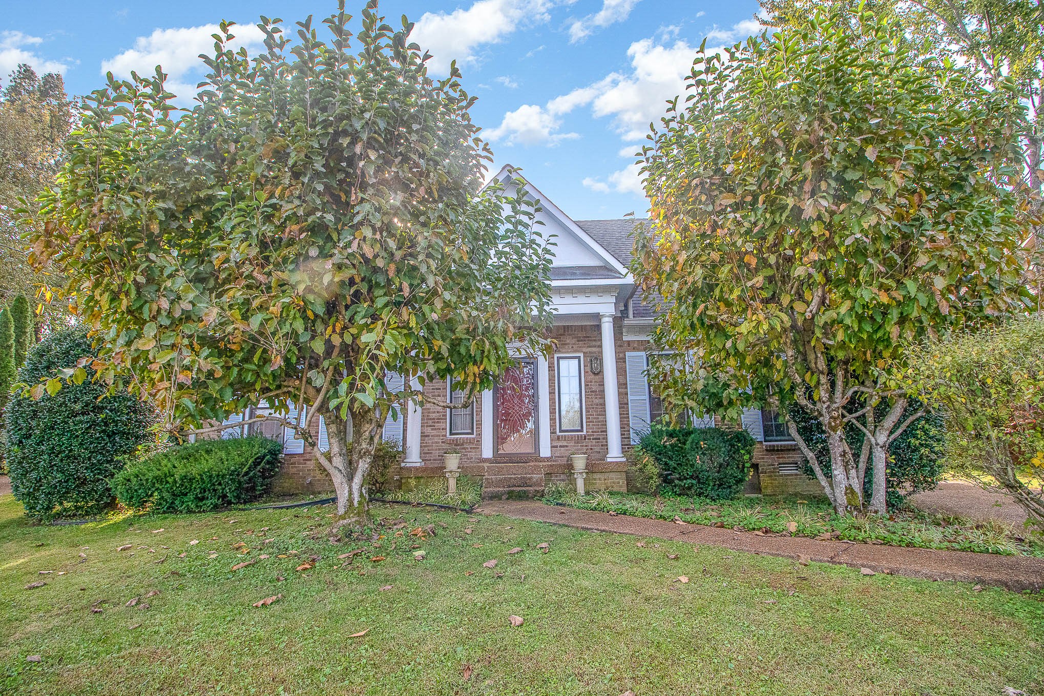 a front view of a house with garden