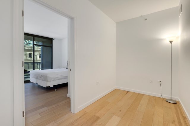 100 East 14th Street, Unit 708 Chicago, IL 60605 - Photo 12 of 25 a view of a room with wooden floor and a window