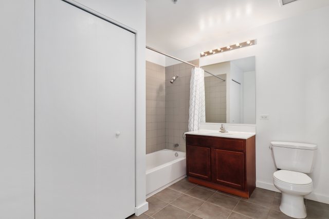 100 East 14th Street, Unit 708 Chicago, IL 60605 - Photo 14 of 25 a bathroom with a toilet sink and mirror