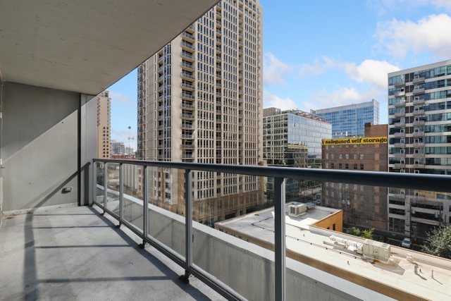 100 East 14th Street, Unit 708 Chicago, IL 60605 - Photo 15 of 25 a view of balcony with a couple of cars parked in front of it