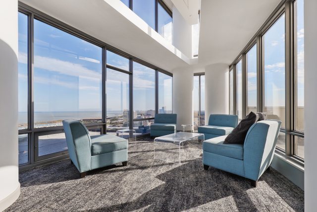 100 East 14th Street, Unit 708 Chicago, IL 60605 - Photo 21 of 25 a living room with furniture and large windows