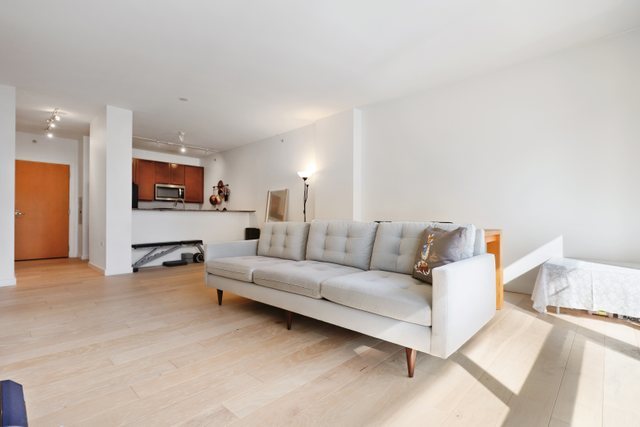 100 East 14th Street, Unit 708 Chicago, IL 60605 - Photo 3 of 25 a living room with furniture and a refrigerator
