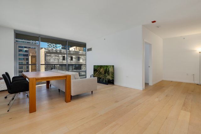 100 East 14th Street, Unit 708 Chicago, IL 60605 - Photo 4 of 25 a living room with furniture and a table