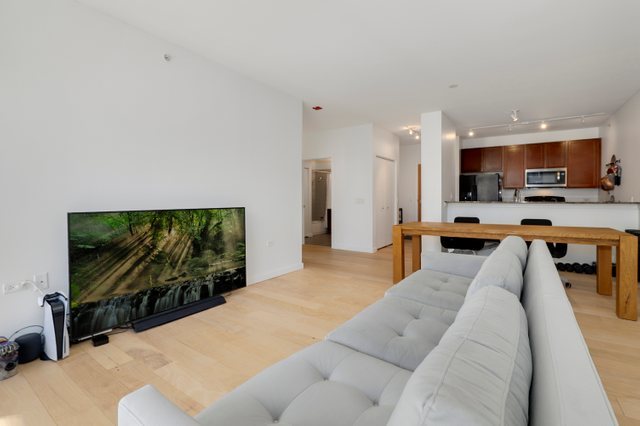 100 East 14th Street, Unit 708 Chicago, IL 60605 - Photo 5 of 25 a living room with stainless steel appliances furniture and a flat screen tv