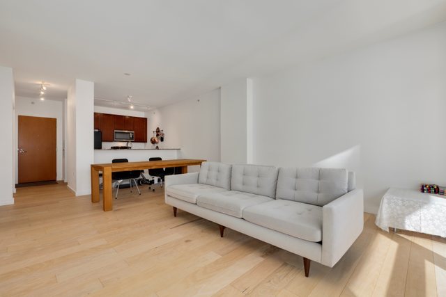 100 East 14th Street, Unit 708 Chicago, IL 60605 - Photo 7 of 25 a living room with furniture and a flat screen tv