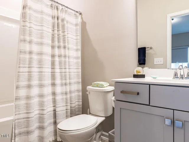a view of a hallway with wooden floor and entryway