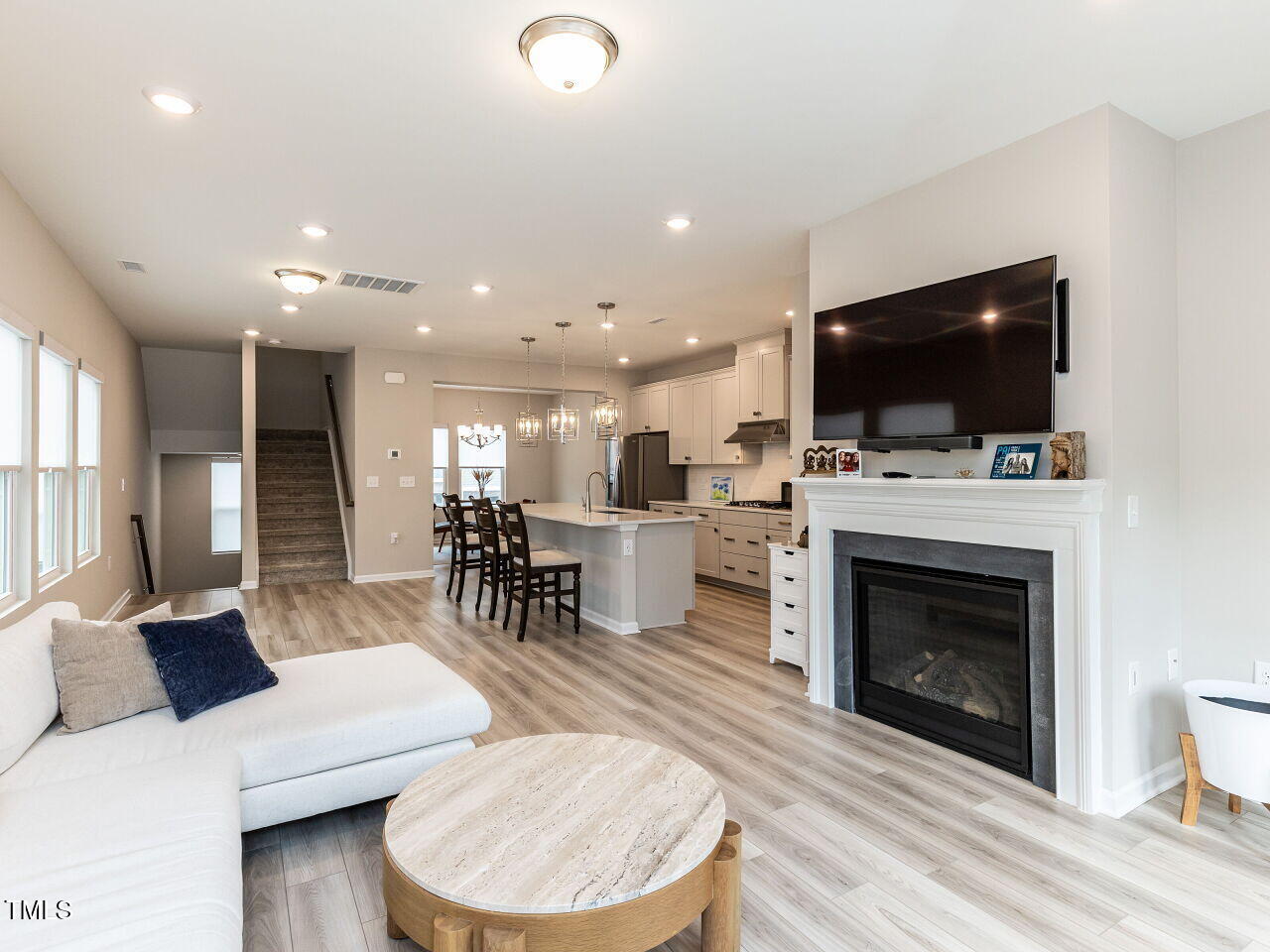 730 Firebrick Drive Cary, NC 27519 - Photo 12 of 38 a living room with furniture a fireplace and a flat screen tv