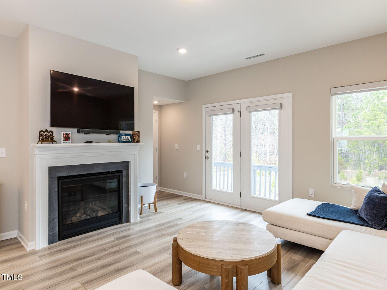 730 Firebrick Drive Cary, NC 27519 - Photo 14 of 38 a living room with furniture a flat screen tv and a fireplace