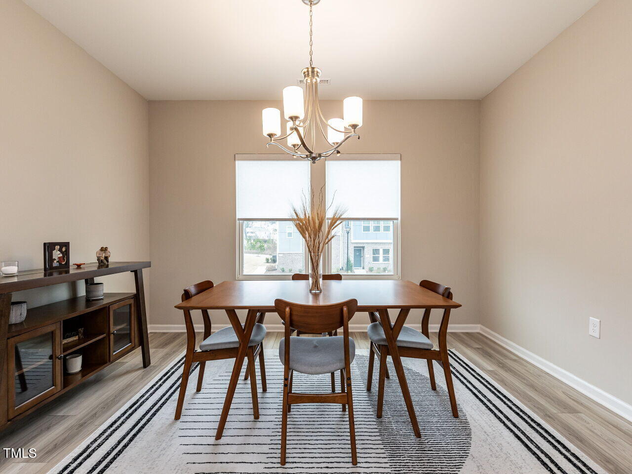 730 Firebrick Drive Cary, NC 27519 - Photo 15 of 38 a dining room with furniture a chandelier and wooden floor