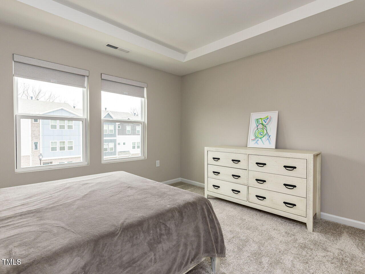 730 Firebrick Drive Cary, NC 27519 - Photo 20 of 38 a spacious bedroom with a bed a dresser and a window