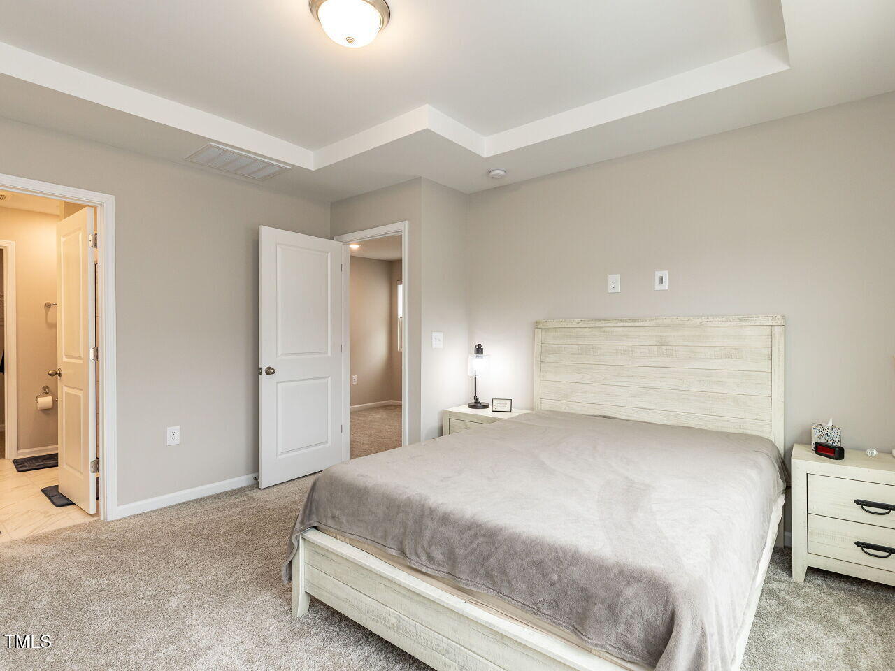 730 Firebrick Drive Cary, NC 27519 - Photo 22 of 38 a bedroom with a bed and a night stand