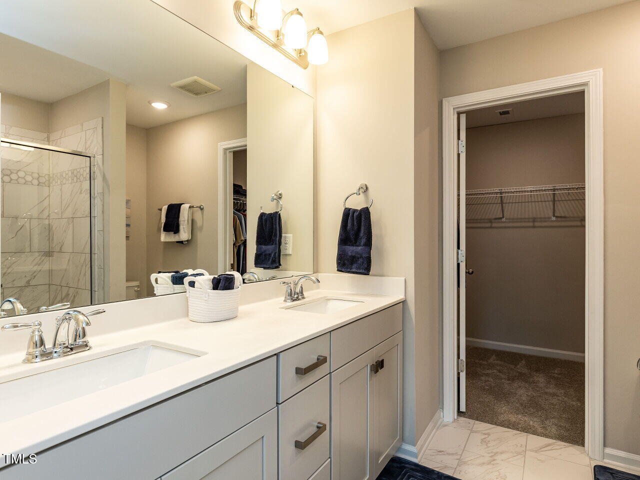 730 Firebrick Drive Cary, NC 27519 - Photo 23 of 38 a bathroom with double sink and a mirror