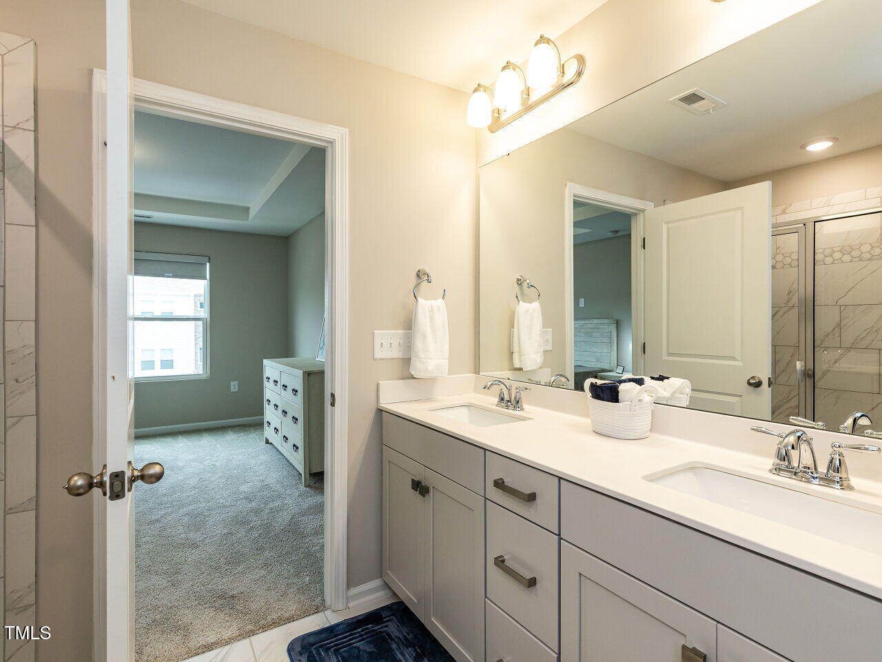 730 Firebrick Drive Cary, NC 27519 - Photo 24 of 38 a bathroom with double sink and a mirror