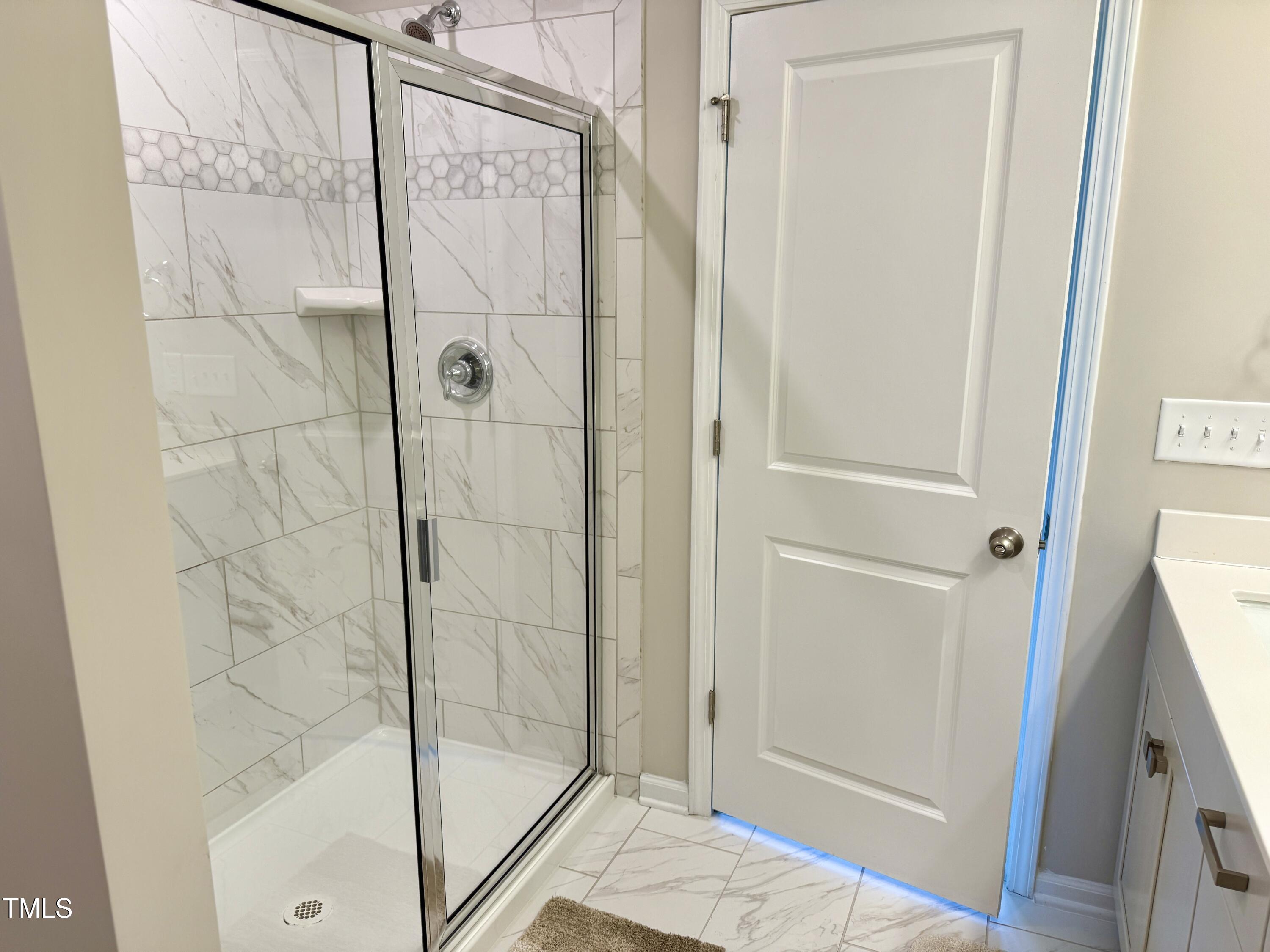 730 Firebrick Drive Cary, NC 27519 - Photo 25 of 38 a bathroom with a glass shower door